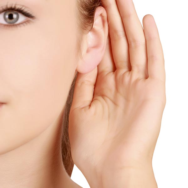 Woman showing off her newly reshaped ears after otoplasty.