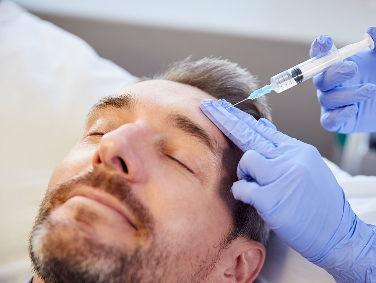 Man receiving a botox injection.