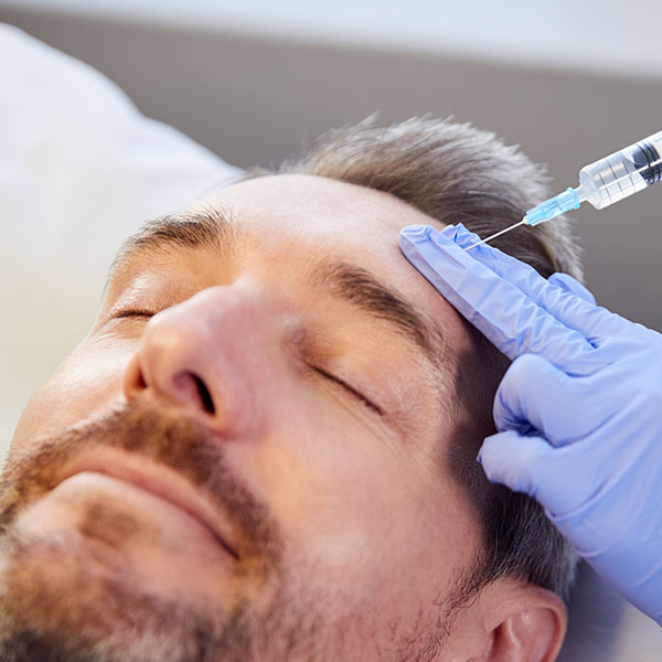 Man receiving a botox injection.