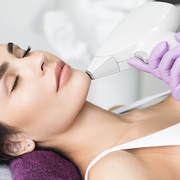 Woman receiving a non-surgical Xeomin treatment around her chin.