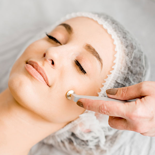 Dianne performing a non-surgical microdermabrasion treatment on a patient.