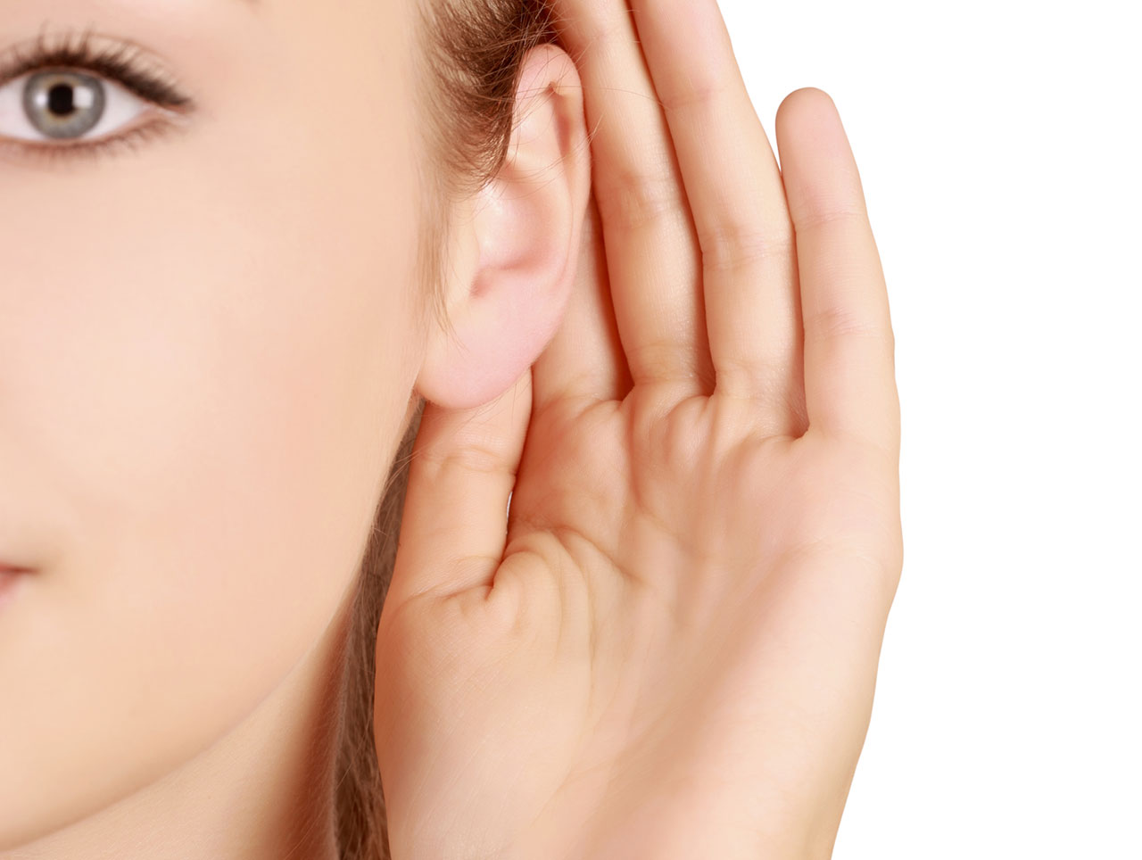 Woman showing off her newly reshaped ears after otoplasty.